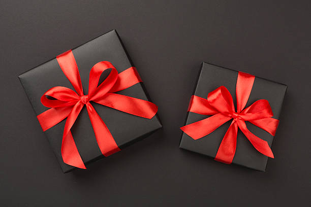 istock Black gift boxes on color background, top view. Black Friday concept 2247685241