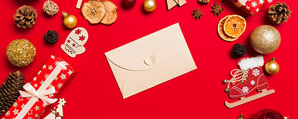 istock Top view of envelope on red background. New Year decorations. Christmas holiday concept 2247685907