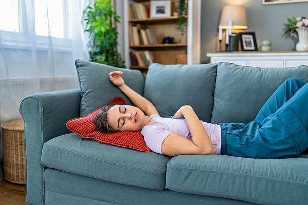 istock Young woman sleeping on sofa feeling relaxed at home 2247686007