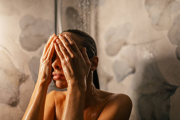 istock Beautiful woman taking a shower 2247686371