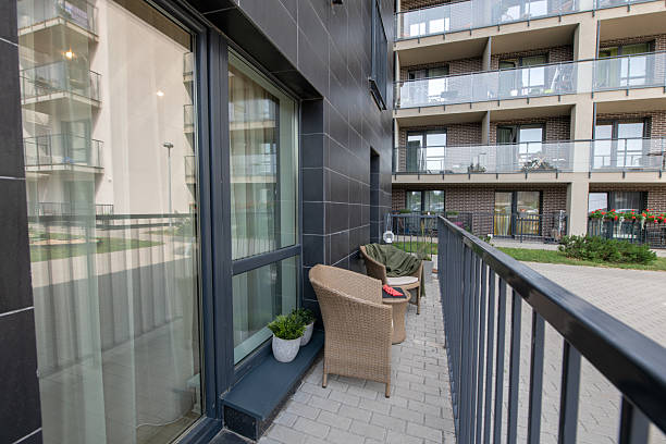 istock Modern Apartment Balcony With Seating and Adjacent Building View 2247690532