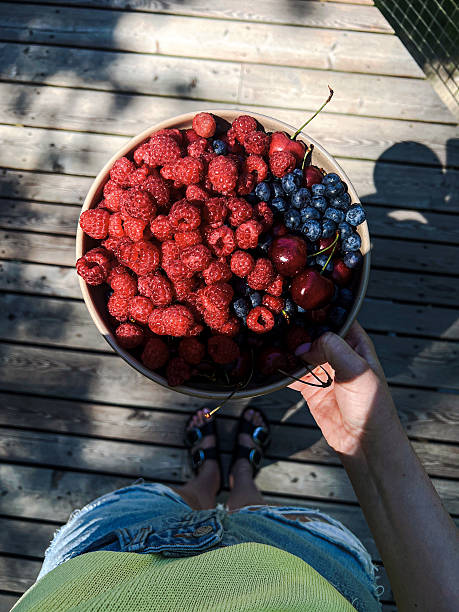 Bowl full of summer berries. Heap of raspberries and blueberries.