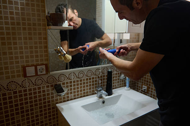 istock Man Grooming At Home: Entrepreneur Father Focused By Sink In Modern Bathroom 2247691297