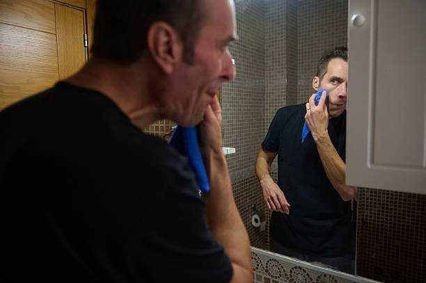 istock Busy Dad Shaving in Bathroom Mirror During Home Office Day 2247691301
