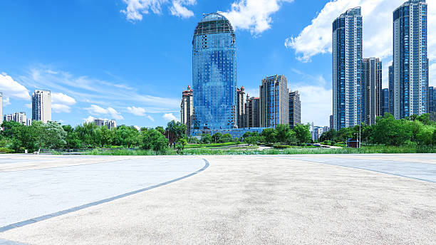 istock Empty square floor with modern urban skyline and sunny blue sky background 2247694457