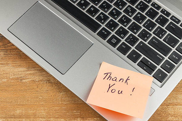 istock Simple thank you note placed on laptop at home workspace 2247695964