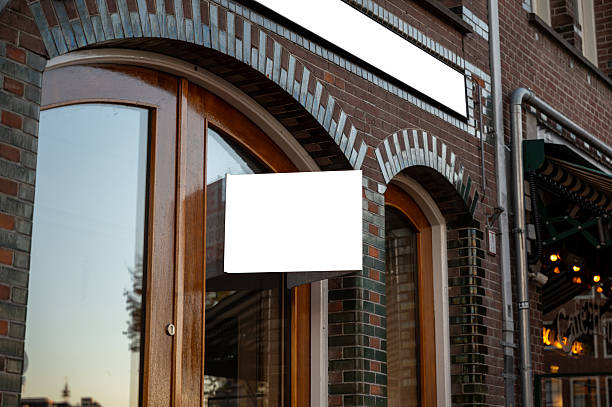 istock Blank shop sign mockup on brick storefront building 2247696965