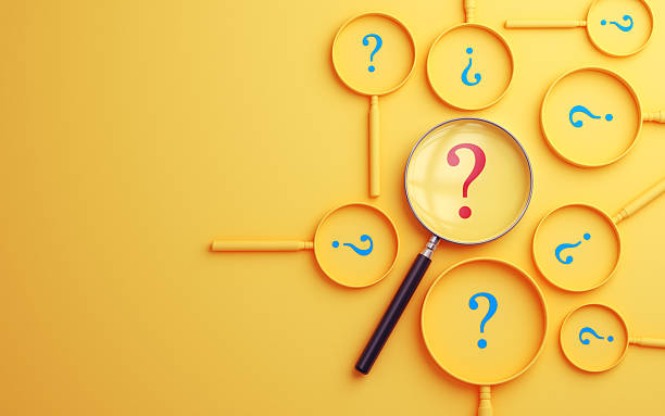 istock Magnifying Glass Highlighting Colorful Question Marks on Yellow Background 2247697135