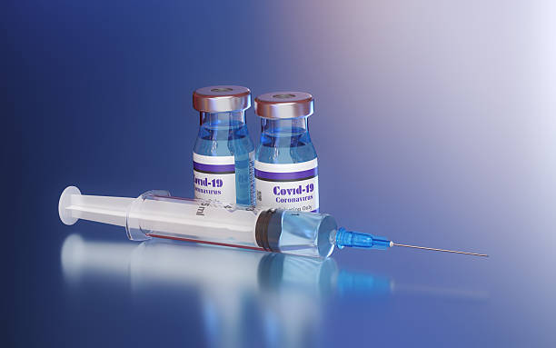 istock COVID-19 Vaccine Vials and Syringe on Blue Gradient Background 2247697164