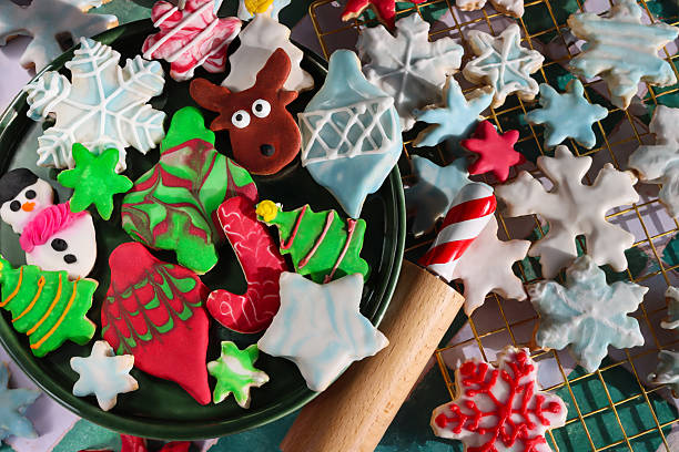 istock Image of rolling pin with mixed christmas cookies, colorful baubles, royal icing patterns featuring snowflakes and stars 2247702029
