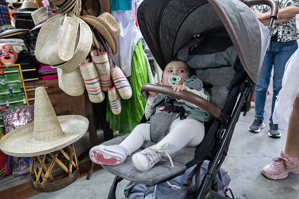 baby sitting in his stroller at a craft market