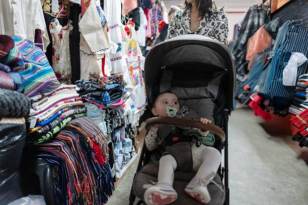 baby sitting in his stroller at a craft market
