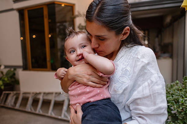 istock mother carrying her baby in her arms affectionately 2247707445