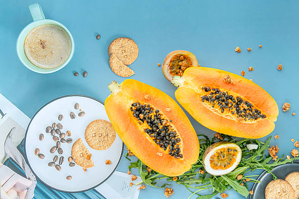 istock Papaya, passion fruit, rucola and granola on a blue background. 2247707715