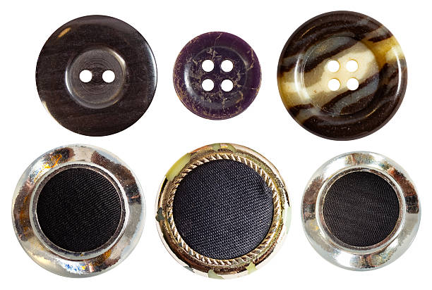 Isolated photo of various colored plastic decorative cloth buttons or rivets on white background.