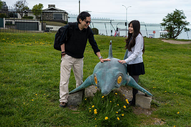 istock Smiling Father and Daughter Interacting with an Ichthyosaur Statue at a Science Park 2247717476