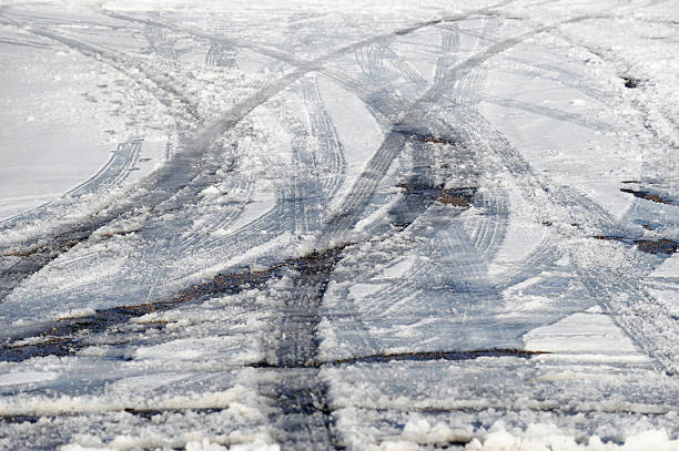 Tire tracks on snow on the road