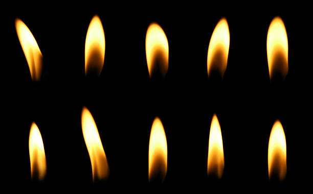 istock A candle flame is burning at night in close range, yellow light isolated on a black background. Concept for taking graphics for birthdays, Halloween, and Christmas. glow wick 2247718407