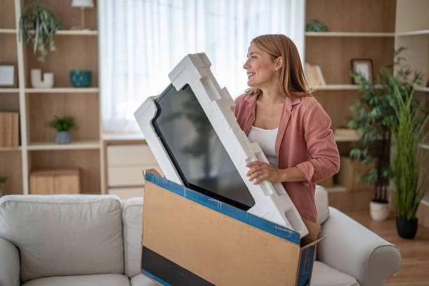 istock An online shopper lifts her new purchase from its box 2247718471