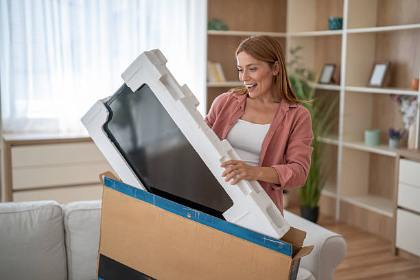 istock An online shopper lifts her new purchase from its box 2247718475