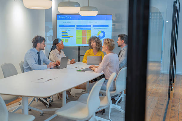 istock Business team analyzing sales data on a large screen in modern office 2247718506