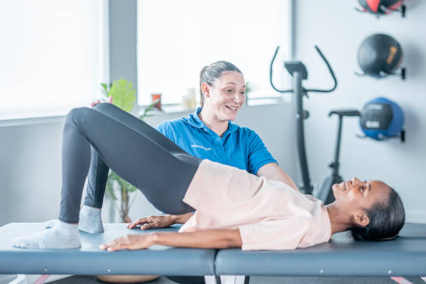istock Fitness Session With Black Female Client Lying On Exercise Table Guided By Female Trainer In Gym 2247718694