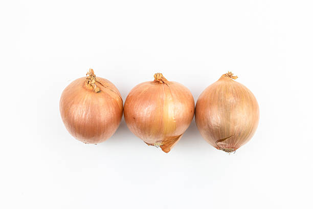 istock Three onions isolated on white background. Top view. Flat lay. 2247720448