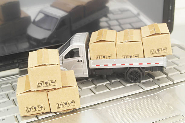 istock Truck model with boxes on laptop computer close up. 2247721998