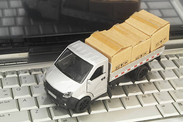 istock Truck model with boxes on laptop computer close up. 2247722030