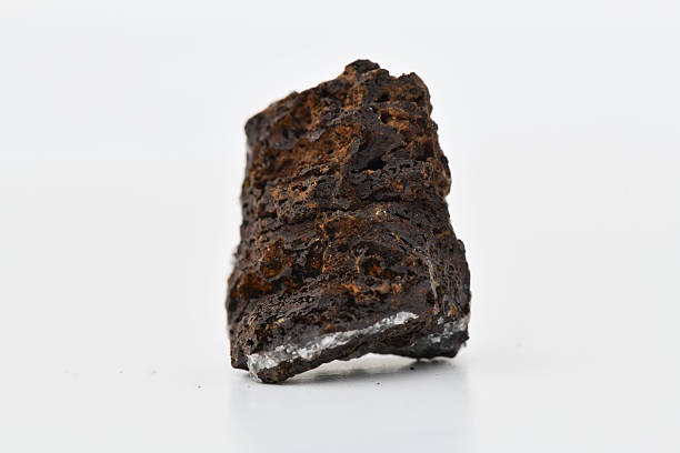 istock Rough Axinite Mineral Cluster with White Crystalline Inclusions 2247729213