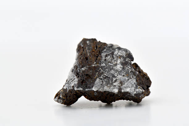 istock Rough Axinite Mineral Cluster with White Crystalline Inclusions 2247729214