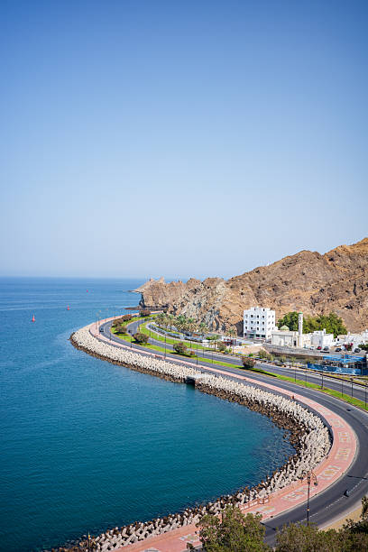 Scenic Coastal Road and Rocky Mountain Shoreline in Muscat, Oman
