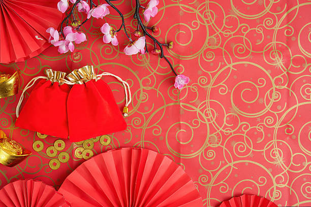 istock Chinese New Year celebration with red envelopes and gold ingots on decorative background 2247736756