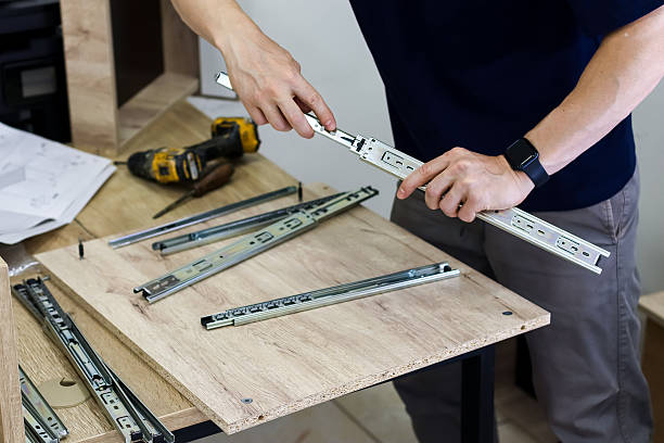 istock Carpenter preparing drawer slides for furniture assembly 2247736798