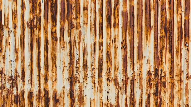 istock Close up of weathered corrugated metal texture with rust streaks 2247737746