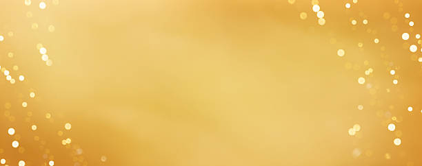 istock Gold color gradient background with defocused light bokeh sources or smooth light transitions. Shiny abstract texture for design, festive celebration, wealth concepts and digital backdrops. Banner. 2247738745