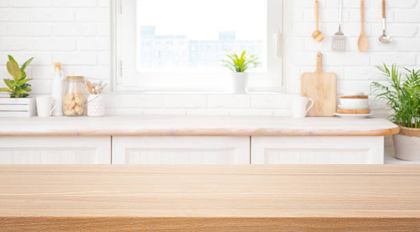 istock Empty wooden table top for product display with blurred rustic kitchen counter interior background 2247738775