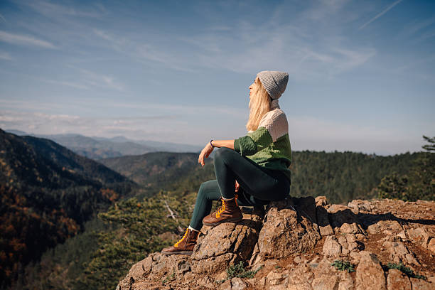 istock Woman enjoying freedom from mountain peak view 2247739636