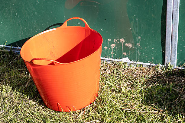 red bucket on green grass at the Devon County Show - May 2025 in Exeter, UK