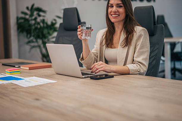istock Businesswoman staying hydrated while working on laptop in modern office 2247741598