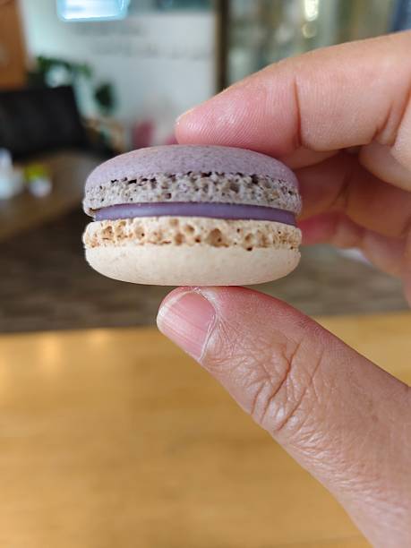 Finger pinching taro macaron.