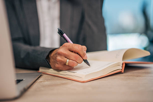 istock Person writing in notebook planning business schedule 2247741827