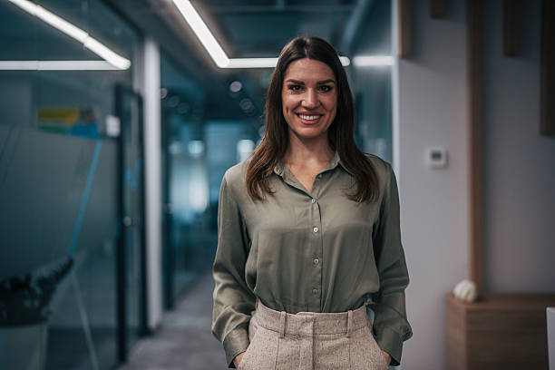 istock Confident businesswoman smiling in modern corporate office setting 2247741844