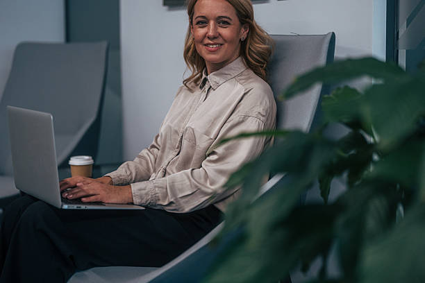 istock Woman smiling while working remotely on laptop 2247744392