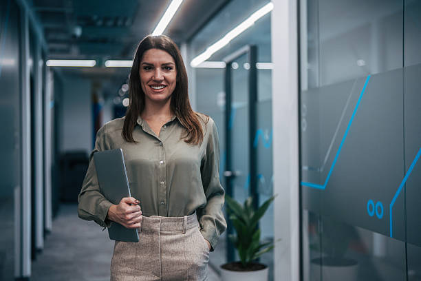 istock Confident businesswoman walking in modern office corridor 2247744513
