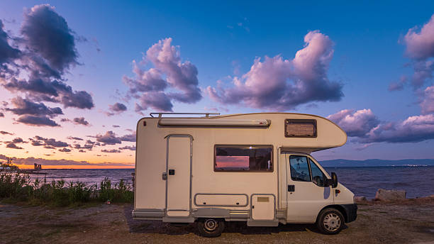 istock Camper van parked by the sea at sunset, under a colorful sky with dramatic clouds. Peaceful evening atmosphere, perfect for travel, adventure, freedom, and outdoor lifestyle themes 2247744536