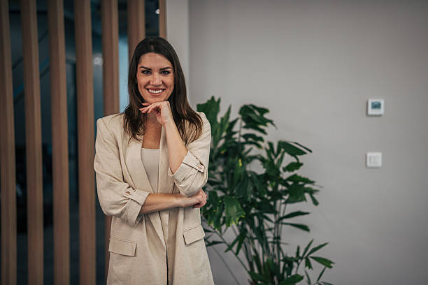 istock Confident businesswoman smiling posing in modern office 2247745475