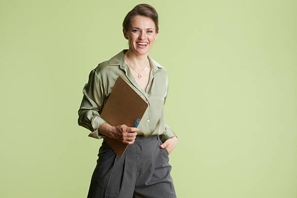 istock Confident woman with clipboard and pen 2247747126