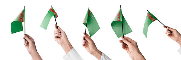 istock The Turkmenistan flag in hand in different angles on a white background 2247747214
