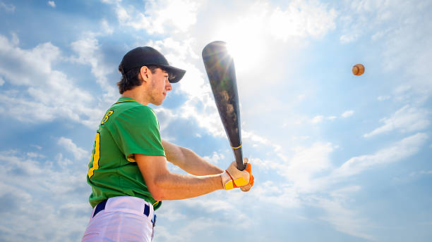 istock Young Caucasian Male Baseball Player Swinging Bat Under Bright Sky 2247747432